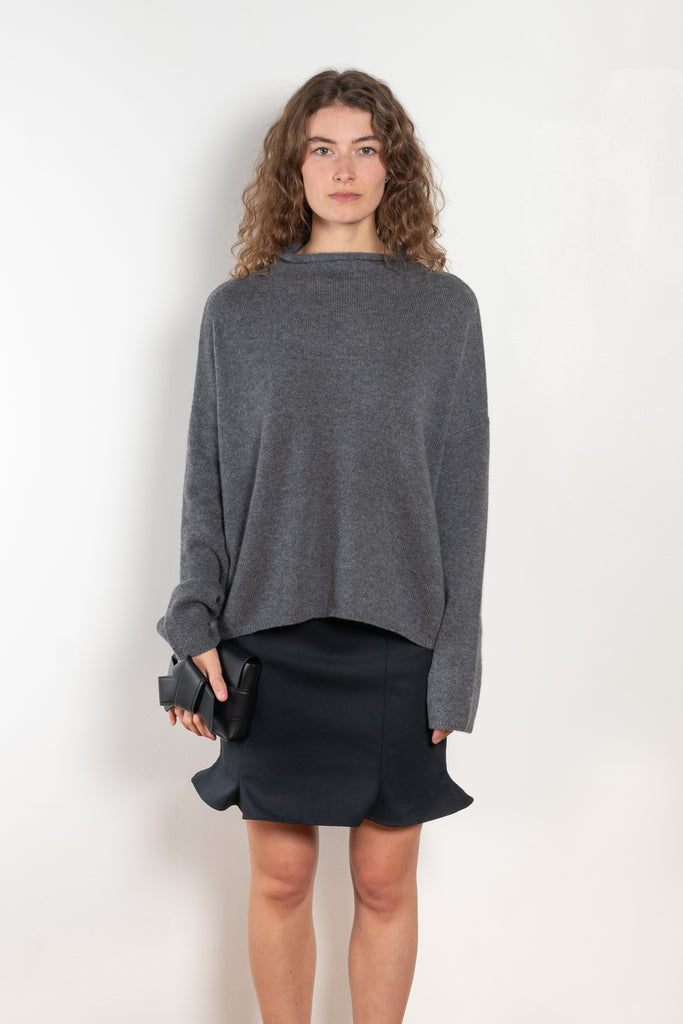 The Sandy Sweater by LISA YANG has a straight fit with dropped shoulders and a raw hem mock neck