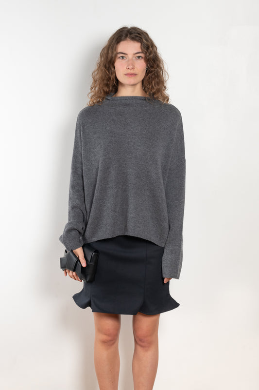 The Sandy Sweater by LISA YANG has a straight fit with dropped shoulders and a raw hem mock neck