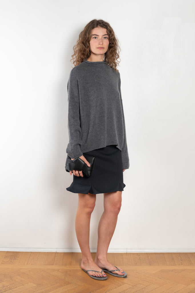 The Sandy Sweater by LISA YANG has a straight fit with dropped shoulders and a raw hem mock neck