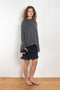 The Sandy Sweater by LISA YANG has a straight fit with dropped shoulders and a raw hem mock neck