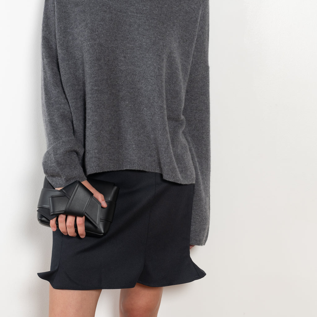 The Sandy Sweater by LISA YANG has a straight fit with dropped shoulders and a raw hem mock neck