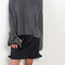 The Sandy Sweater by LISA YANG has a straight fit with dropped shoulders and a raw hem mock neck