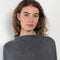 The Sandy Sweater by LISA YANG has a straight fit with dropped shoulders and a raw hem mock neck