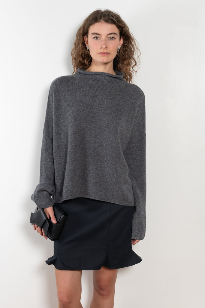 The Sandy Sweater by LISA YANG has a straight fit with dropped shoulders and a raw hem mock neck