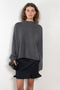 The Sandy Sweater by LISA YANG has a straight fit with dropped shoulders and a raw hem mock neck