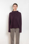 The Sandy Sweater by LISA YANG has a straight fit with dropped shoulders and a raw hem mock neck
