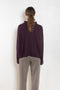 The Sandy Sweater by LISA YANG has a straight fit with dropped shoulders and a raw hem mock neck