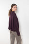 The Sandy Sweater by LISA YANG has a straight fit with dropped shoulders and a raw hem mock neck