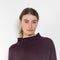 The Sandy Sweater by LISA YANG has a straight fit with dropped shoulders and a raw hem mock neck