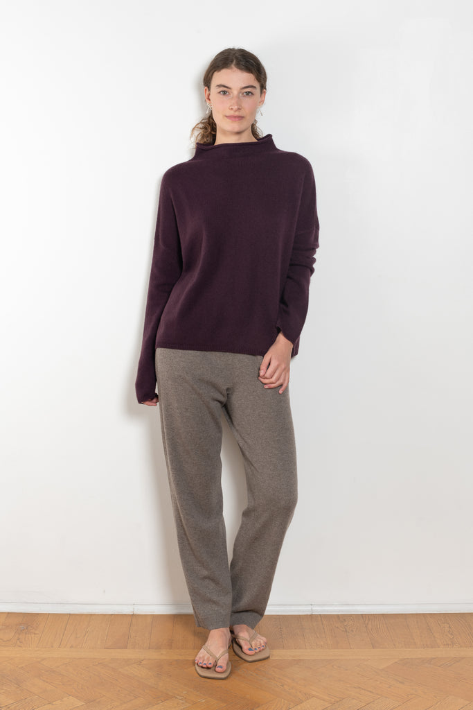 The Sandy Sweater by LISA YANG has a straight fit with dropped shoulders and a raw hem mock neck