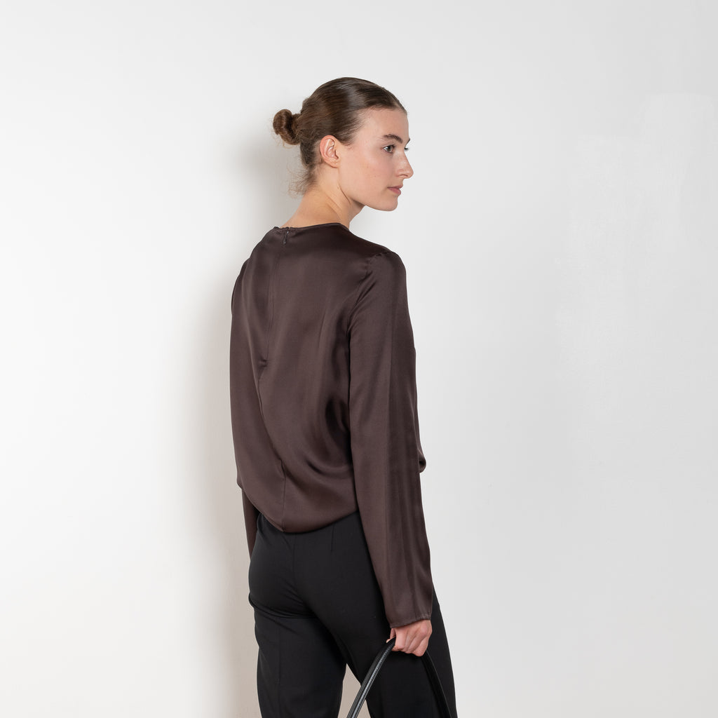 The Azae Blouse by Loulou Studio is a refined silk twill blouse with a draped detail and hardware embellishment