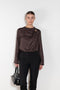 The Azae Blouse by Loulou Studio is a refined silk twill blouse with a draped detail and hardware embellishment