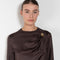 The Azae Blouse by Loulou Studio is a refined silk twill blouse with a draped detail and hardware embellishment