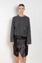 The Bill Sweater by Loulou Studio is thick soft cashmere sweater with a draped detail and an hardware embellishment