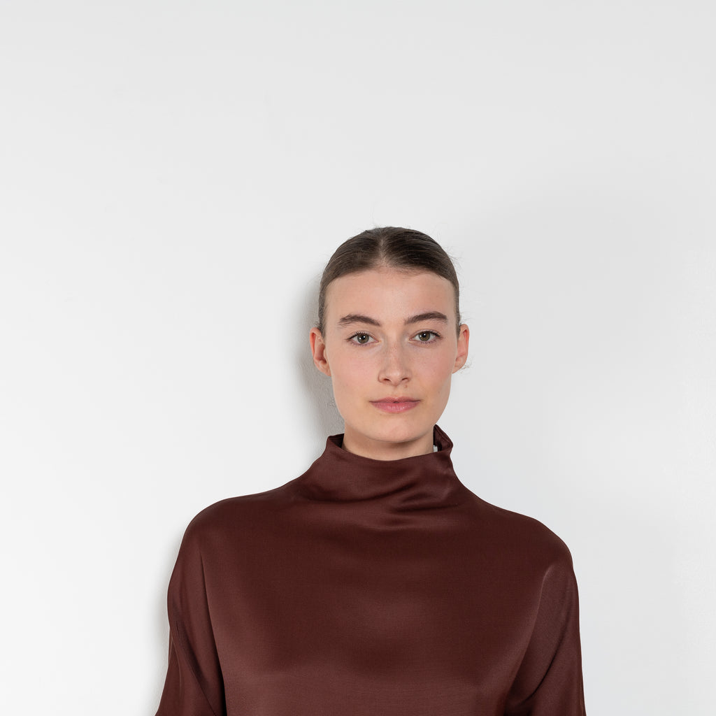 The Elton Mini Dress by Loulou Studio is a mini dress with a high standing collar and two side pockets