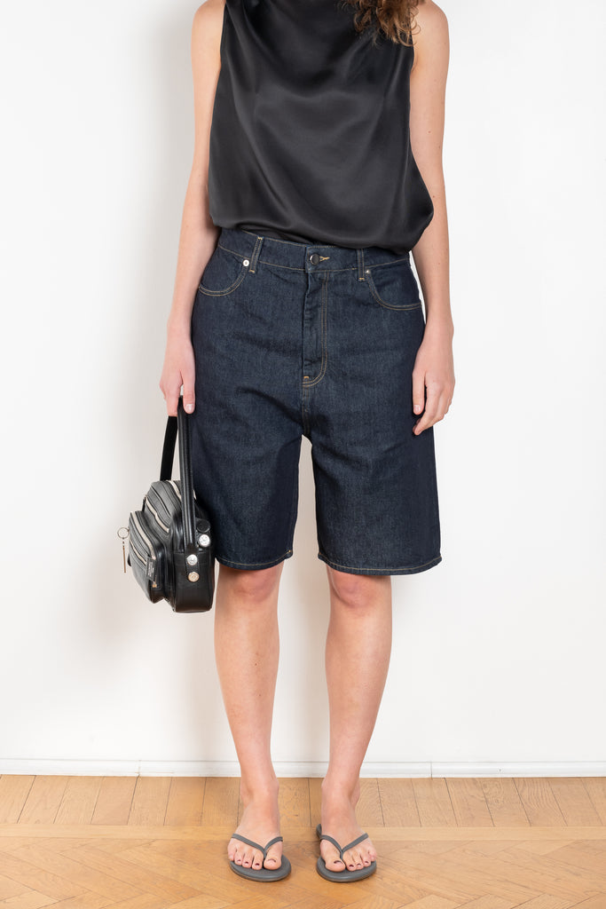 The Isu Short by Loulou Studio is a mid rise jeans short with bermuda-like proportions