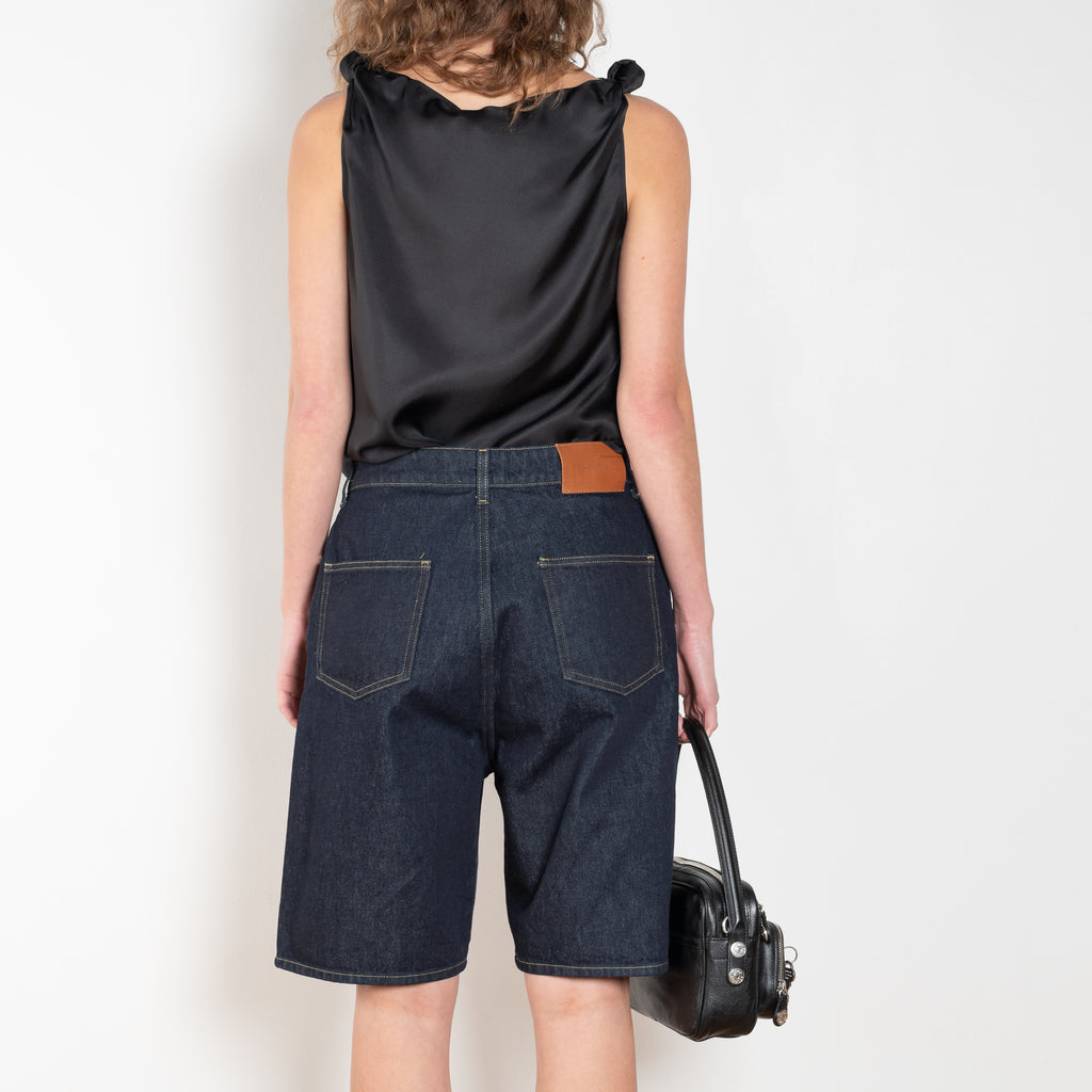 The Isu Short by Loulou Studio is a mid rise jeans short with bermuda-like proportions