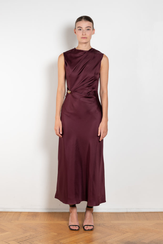 The Roan Dress by Loulou Studio is an elegant evening dress with a draped detail and hardware embellishment in a fluid silk twill