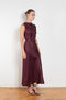 The Roan Dress by Loulou Studio is an elegant evening dress with a draped detail and hardware embellishment in a fluid silk twill