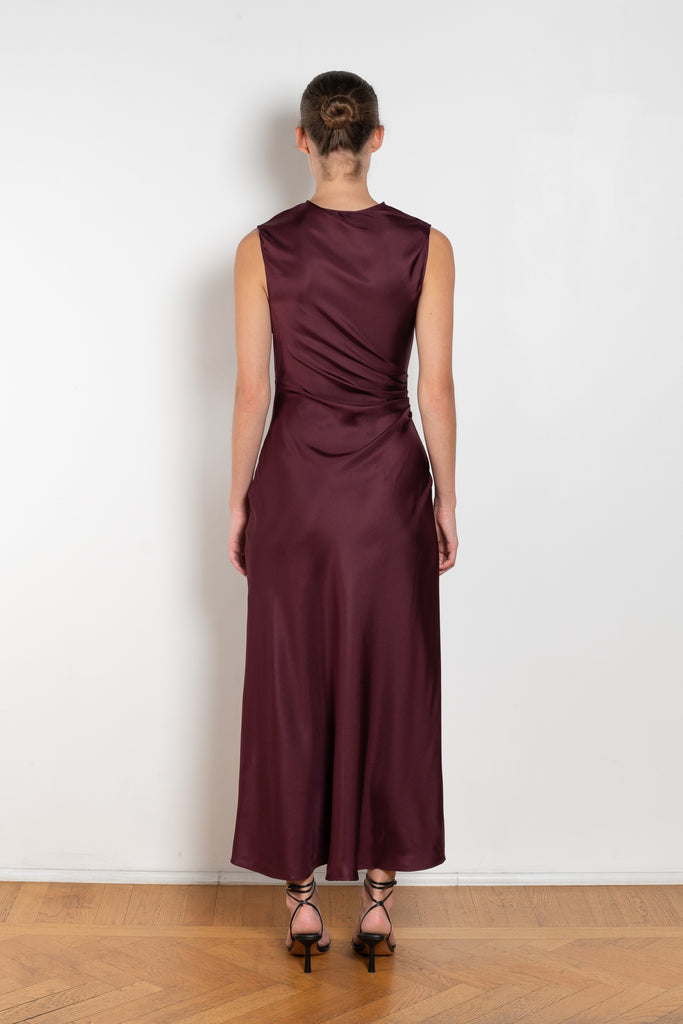 The Roan Dress by Loulou Studio is an elegant evening dress with a draped detail and hardware embellishment in a fluid silk twill