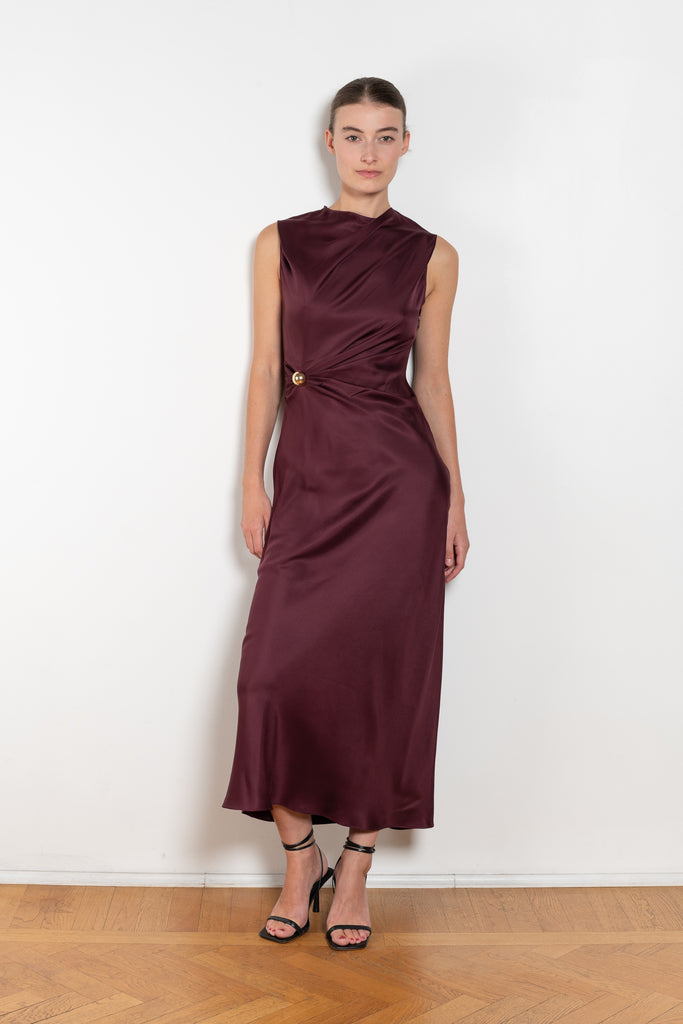 The Roan Dress by Loulou Studio is an elegant evening dress with a draped detail and hardware embellishment in a fluid silk twill
