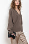 The Sage Sweater by Loulou Studio is an oversized sweater with an ample fit, a deep V, dropped shoulders