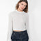 The Tinos Top by Loulou Studio is a cropped knit with a lace pattern