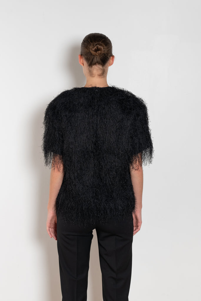 The Zaro Top by Loulou Studio is a short sleeve top with a round neck and long fringes
