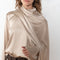 The Silk Shirt by Magda Butrym is a long-sleeve silk blouse with a round neck and carefully draped fabric that gives way to a dramatic cape that sweeps off the shoulder