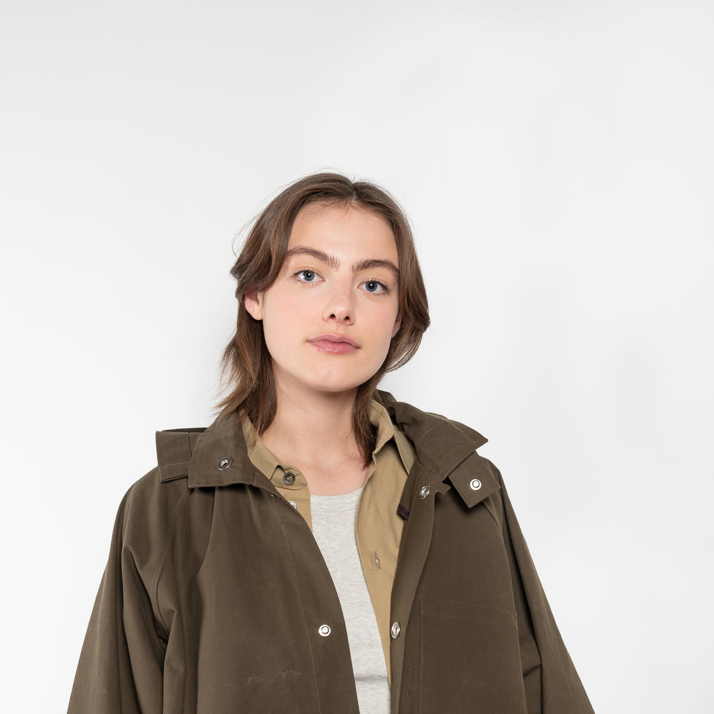 The Parka Coat Oil by Maud Van Den Beussche is a long parka in a structured cotton with detachable hood