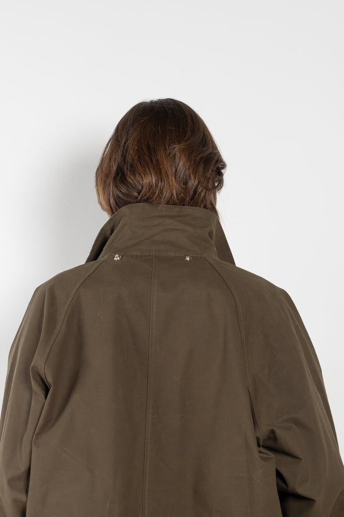 The Parka Coat Oil by Maud Van Den Beussche is a long parka in a structured cotton with detachable hood