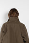 The Parka Coat Oil by Maud Van Den Beussche is a long parka in a structured cotton with detachable hood