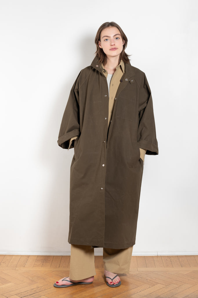 The Parka Coat Oil by Maud Van Den Beussche is a long parka in a structured cotton with detachable hood