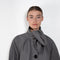 The Bandana Trench by Meryll Rogge is a trench coat crafted in trench cotton, featuring a bandana collar, raglan sleeves and a button closure.
