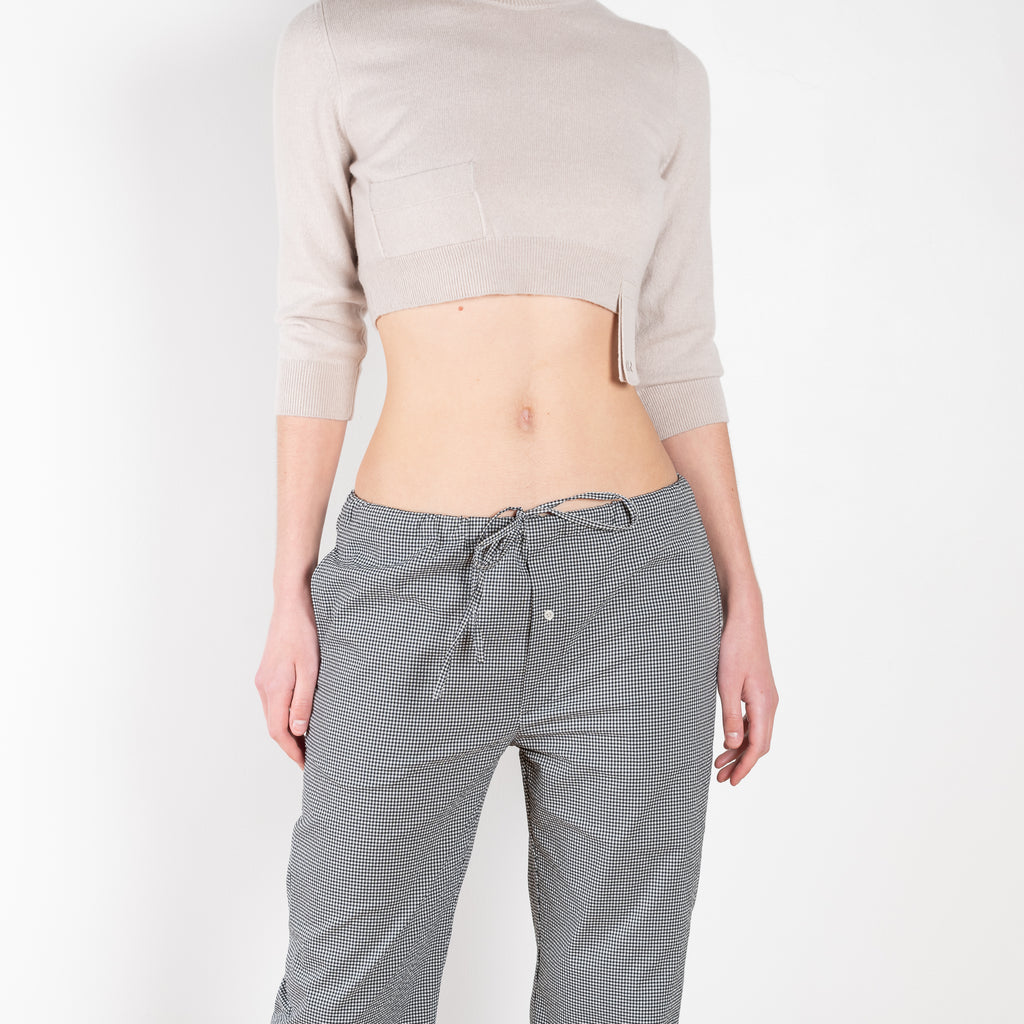 The Checked Pants by Meryll Rogge are low waisted relaxed trousers with a cropped kick flare and drawstring closure