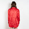The Classic Shirt by Meryll Rogge is a loose overshirt in a vibrant crinkled red satin fabric