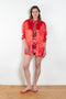 The Classic Shirt by Meryll Rogge is a loose overshirt in a vibrant crinkled red satin fabric