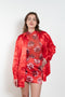 The Classic Shirt by Meryll Rogge is a loose overshirt in a vibrant crinkled red satin fabric