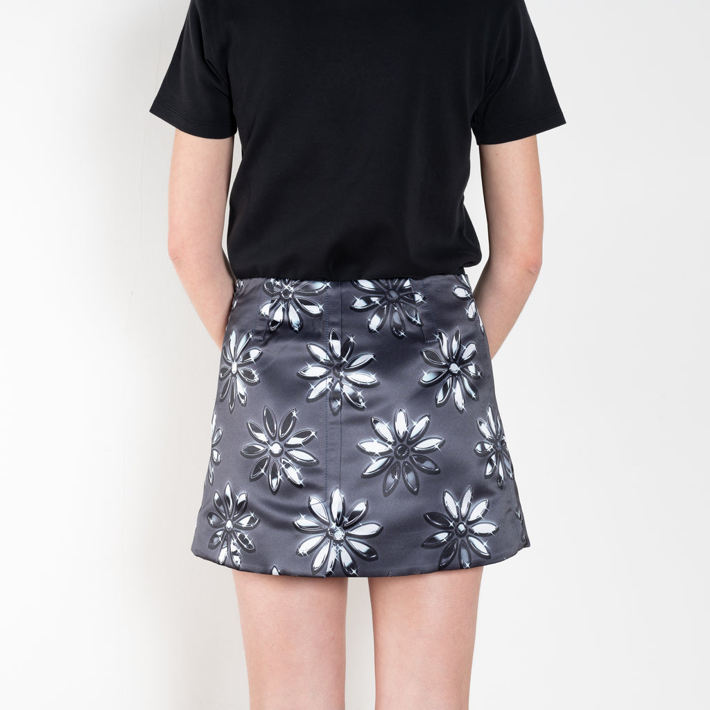 The Daisy Scuba Mini Skirt by Meryll Rogge is a fitted short skirt in a floral embroidery scuba fabric