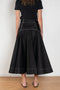 The Flared Workwear Skirt by Meryll Rogge is a long cotton skirt with a flat front and flared fit on the back