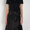The Flared Workwear Skirt by Meryll Rogge is a long cotton skirt with a flat front and flared fit on the back