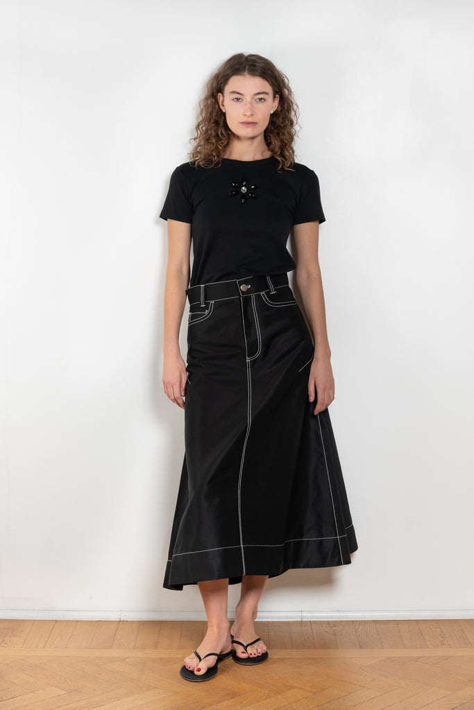 The Flared Workwear Skirt by Meryll Rogge is a long cotton skirt with a flat front and flared fit on the back