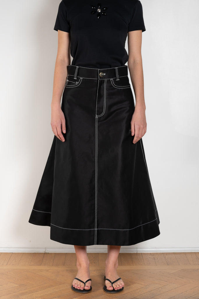 The Flared Workwear Skirt by Meryll Rogge is a long cotton skirt with a flat front and flared fit on the back