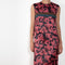 The Long Shift Dress by Meryll Rogge is a sleeveless shift dress crafted in floral scuba satin, featuring a round neckline and a contrasting ribbon detail.