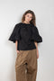 The Ruffled Back Drape Top by Meryll Rogge is a crisp cotton top with an open back and a back draped detail