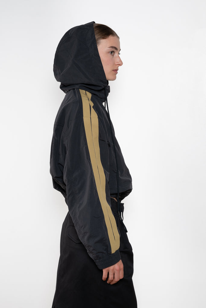 The Sporty Jacket by Meryll Rogge crafted in nylon, featuring a hood, contrast stripe panels, drawstring details and a zip closure
