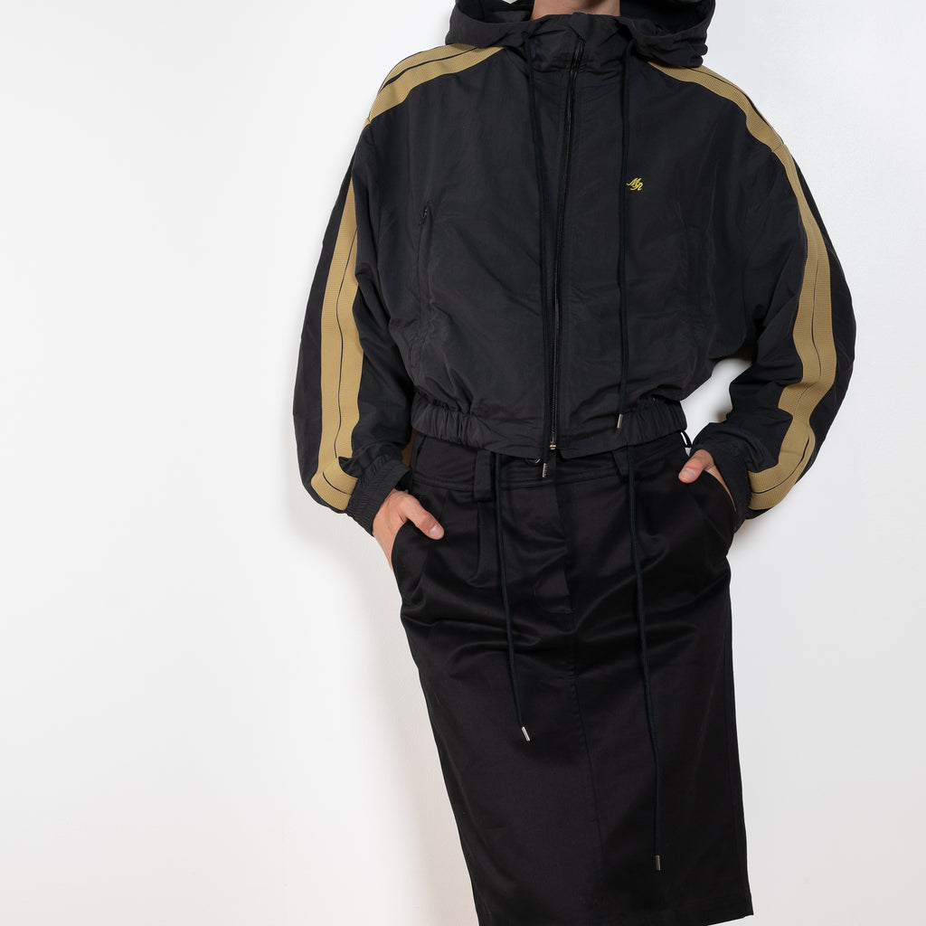 The Sporty Jacket by Meryll Rogge crafted in nylon, featuring a hood, contrast stripe panels, drawstring details and a zip closure