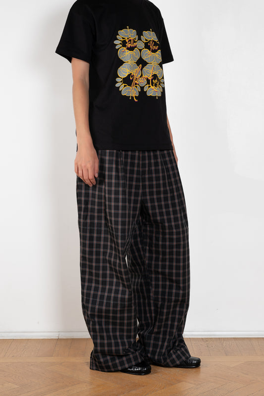 The Workwear Drawstring Chino by Meryll Rogge crafted in grey/black/red checked cotton, featuring a wide-leg silhouette and turned-up hems.