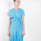 The Long Draped Dress by Meryll Rogge is a long dress with a sensual draping at the waist