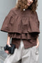 The Ruffle Tiered Top by Meryll Rogge is a crisp cotton top with layered ruffles that can be tucked into your trousers